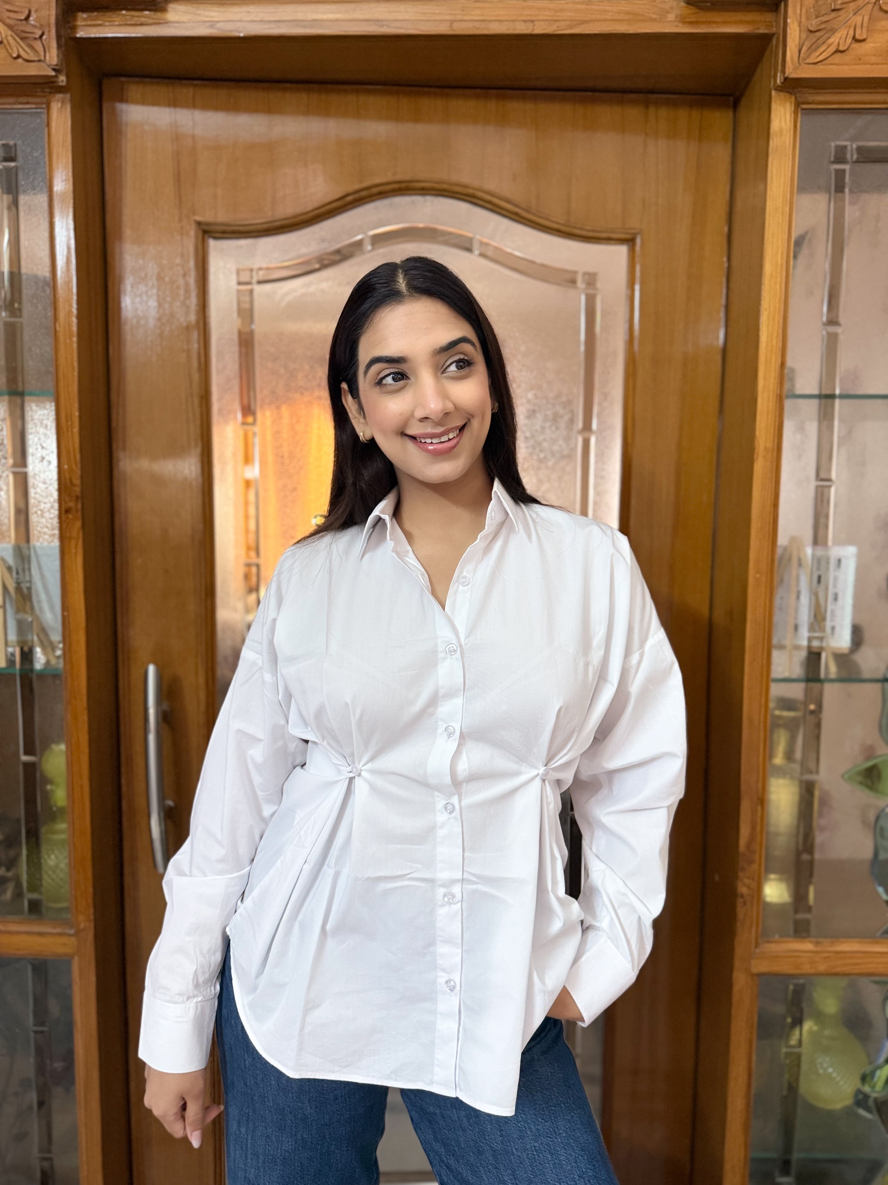 White cotton shirt cinched waist detail close-up
