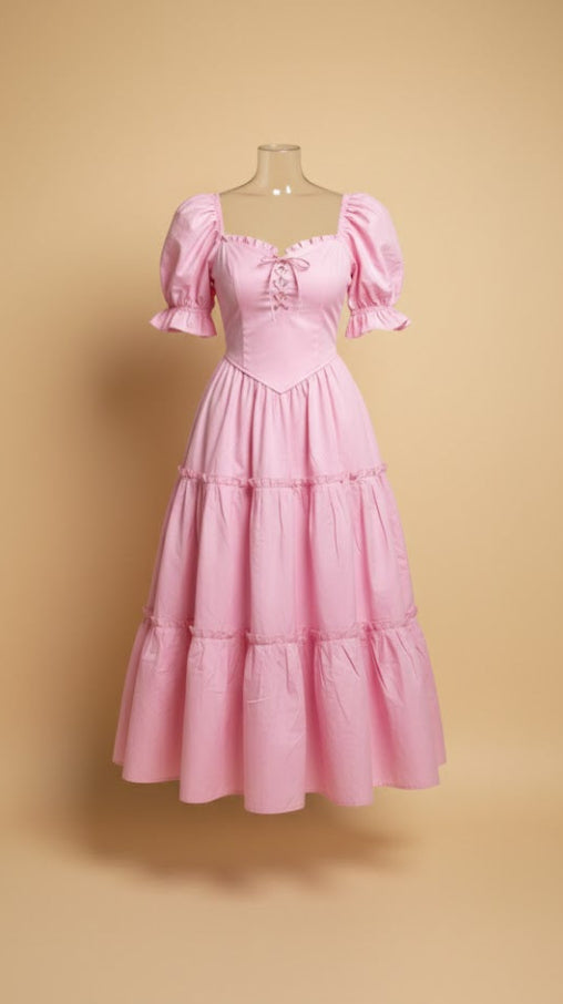Pink vintage-style dress on a mannequin against a beige background